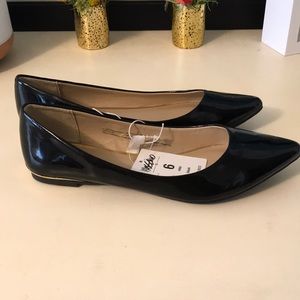 Black patent flats with gold accents